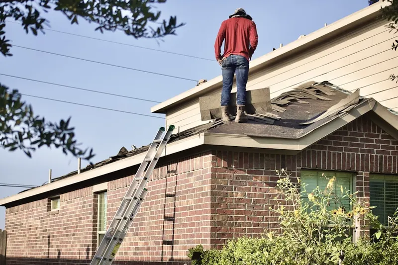 Professional roofer working on a residential roof in Teaneck